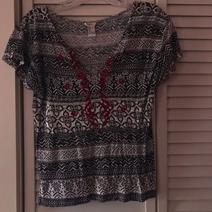 black and white patterned tee with red embroidery